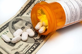 Pills Falling Out of Prescription Bottle onto Money