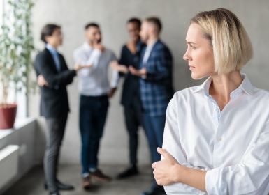 Woman standing apart from a group, symbolising isolation and stress after a fatal DUI accident